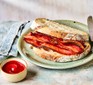 Air fryer bacon in a sandwich with ketchup on the side