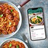 BBC Good Food Premium App next to a pan of spaghetti and meatballs