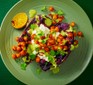 A serving of baked sweet potato with whipped feta, spiced chickpeas & green tahini