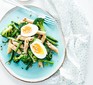 A plate of broccoli pasta salad with eggs & sunflower seeds