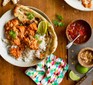 Chicken curry in bowl with rice and naan bread