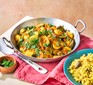 Courgette curry in a pan with lemon rice on the side