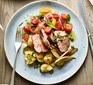 Cumin-crusted lamb with shallots & crushed new potatoes served on a plate