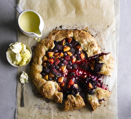 rustic fruit harvest pie with three slices pulled slightly out