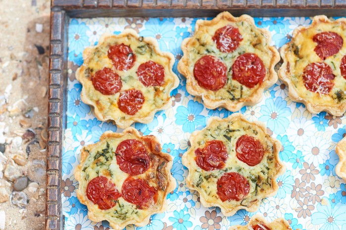 Mini quiches with chorizo on a blue tray