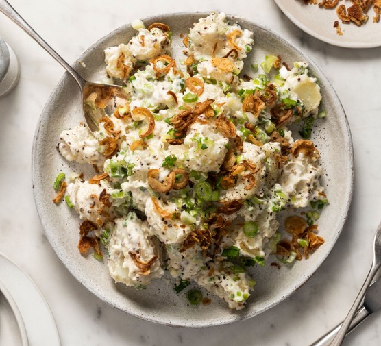 Potato salad in dish with spoon