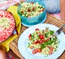 Pesto pasta salad served in tupperware and on a plate