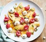 Peach & raspberry fruit salad with mascarpone served on a plate