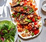 Roast puttanesca aubergines with tomato rice & feta on an oval dish