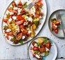 Tomato, goat’s curd & basil salad with raspberry vinegar dressing served on a plate