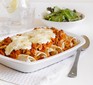 Vegetarian enchiladas in a baking dish covered with cheese